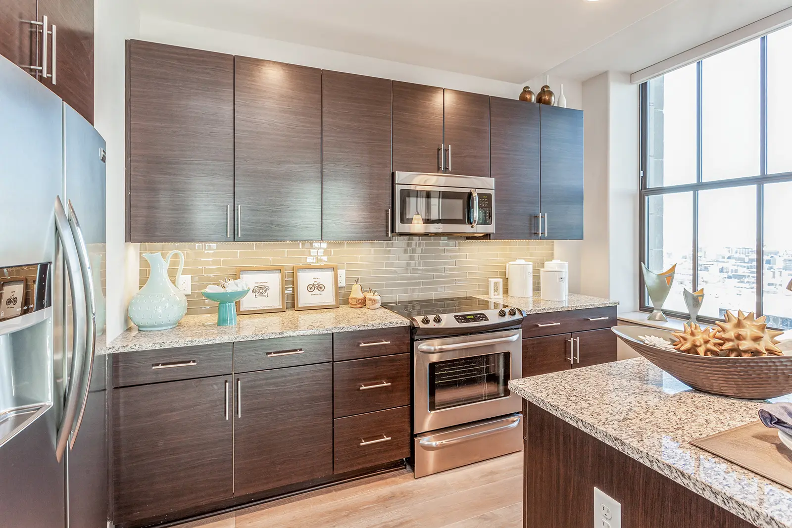 luxury baltimore apartment kitchen with stainless steel appliances and wood cabinets